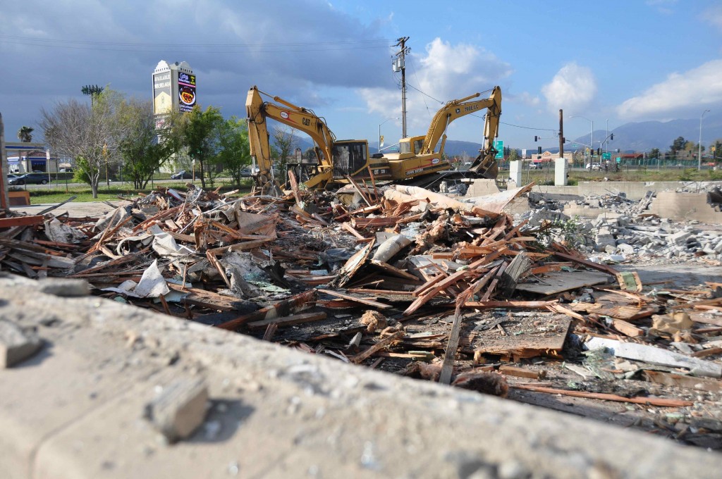 A bulldozer finishes tearing down a dilapidated and abandoned fire station at 1925 N. Riverside Ave. It will now begin a project to upgrade infrastructure on the property, to make it suitable for new development. The City will soon also build a new fire station. Photo by Chris Sloan