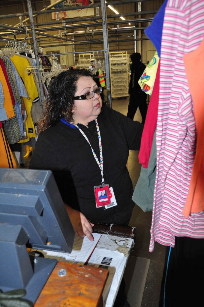 Patricia Luna, warehouse supervisor, prices clothing donated to the Salvation Army Adult Rehabilitation Center. The Adult Rehabilitation Center seeks donations of all household items for its seven Family Stores, proceeds of which fund the drug and alcohol rehabilitation program. Photo by Chris Sloan