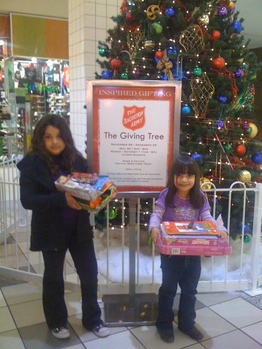 Arlene and Priscilla Delgado, ages 4 and 8, each used their savings to purchase Christmas toys for a less fortunate child through the Salvation Army San Bernardino Corp’s Giving Tree program at Inland Center Mall. Help the Salvation Army obtain more toys for children in need by going to the Giving Tree near the mall’s Food Court. Photo by Kelly Silvestri-Raabe