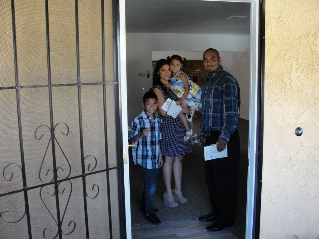 “We in our new house!” Left to right Steven Jr., Jessica, Aubrey and Steven Espinoza, stand in their fully finished living room for the first time. 