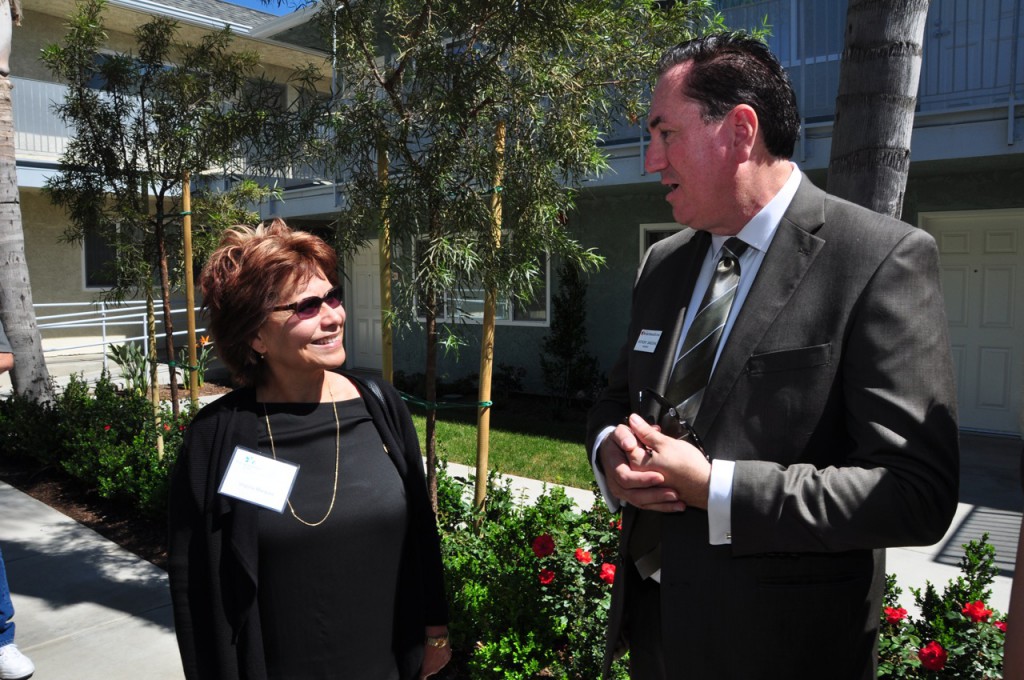(Left to Right) Virgina Marqez, 15th Ward City Counsel Member of San Bernardino and Anthony Sandoval, Western Senior Housing President discuss the apartments beauty in the court yard.