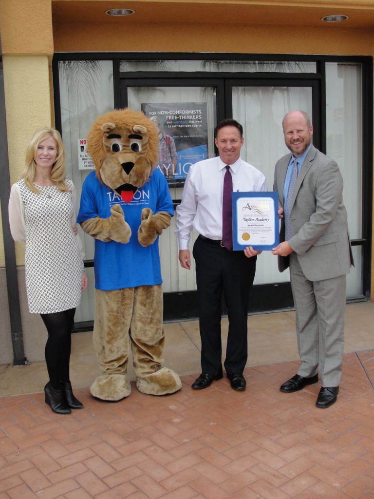 Left to right - Shannon Smith, vice president of Taylion Academy, Tay Lion the mascot, from Jon Gaede, field representative of Assemblymember Cheryl Brown and Tim Smith president of Taylion Acadamy.