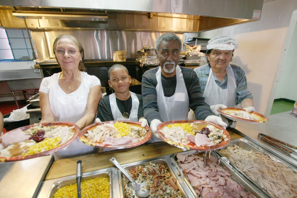 Volunteers serve Thanksgiving Dinner at The Salvation Army: Serving on the food line (left to right) is Nancy Veaegas, Niyahn Summey, Walt Summey, and Robert Sanchez. We are ready for Christmas Dinners. 